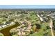 Panoramic aerial view of the community featuring homes, golf course, and lakes at 838 Carnoustie Dr, Venice, FL 34293