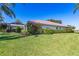 Beautifully landscaped backyard with a screened lanai and lush green lawn at 838 Carnoustie Dr, Venice, FL 34293