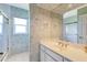 Bathroom featuring a dual sink vanity and bathtub with shower at 838 Carnoustie Dr, Venice, FL 34293