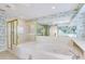 Elegant bathroom featuring soaking tub, glass shower, and a large mirror at 838 Carnoustie Dr, Venice, FL 34293