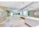 Bright bathroom featuring a soaking tub, walk-in shower and large mirrors at 838 Carnoustie Dr, Venice, FL 34293