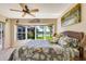 Bright bedroom with waterfront views, ceiling fan, and comfortable bed at 838 Carnoustie Dr, Venice, FL 34293