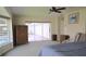 Open bedroom with a sliding glass door leading to a screened lanai and pool area at 838 Carnoustie Dr, Venice, FL 34293