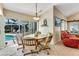 Cozy dining area with wood table, chairs and sliding doors to outdoor pool at 838 Carnoustie Dr, Venice, FL 34293