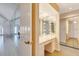 Bright dressing area with a Hollywood-style vanity and mirrored closet doors at 838 Carnoustie Dr, Venice, FL 34293