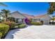 Attractive single-story home featuring a tile roof and beautifully landscaped front yard at 838 Carnoustie Dr, Venice, FL 34293