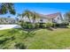 Attractive single-story home featuring a tile roof and manicured lawn at 838 Carnoustie Dr, Venice, FL 34293