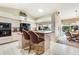 Open kitchen with an island, barstool seating, and access to the dining room at 838 Carnoustie Dr, Venice, FL 34293
