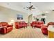 Open living room with vaulted ceilings, fan and neutral carpet and furnishings at 838 Carnoustie Dr, Venice, FL 34293