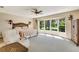 Main bedroom featuring a large bay window and comfortable sitting area at 838 Carnoustie Dr, Venice, FL 34293