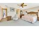 Well-lit main bedroom with large bed and wicker accents at 838 Carnoustie Dr, Venice, FL 34293