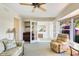 Cozy sitting room with comfortable chairs and a view of vibrant purple flowers at 838 Carnoustie Dr, Venice, FL 34293