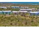 Overhead view of vibrant condo buildings surrounded by trees and water at 8409 Placida Rd # 206, Placida, FL 33946