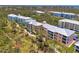Aerial view of condo community nestled in a lush, tree-filled setting at 8409 Placida Rd # 206, Placida, FL 33946