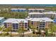 Aerial view of multi-Gathering property featuring condo buildings with private balconies and community landscaping at 8409 Placida Rd # 206, Placida, FL 33946