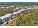 Scenic aerial view of colorful condos surrounded by lush greenery and a glimpse of the ocean at 8409 Placida Rd # 206, Placida, FL 33946