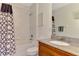 Bathroom featuring shower-tub combo with patterned curtain, granite countertop, and soft lighting at 8409 Placida Rd # 206, Placida, FL 33946