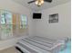 Cozy bedroom with striped bedding, ceiling fan, and window providing natural light at 8409 Placida Rd # 206, Placida, FL 33946