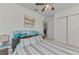 Bedroom featuring striped bedding, closet, neutral paint, and ceiling fan at 8409 Placida Rd # 206, Placida, FL 33946