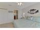 Bright bedroom with ceiling fan and view to on-suite bathroom at 8409 Placida Rd # 206, Placida, FL 33946