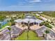Aerial shot of the clubhouse, showcasing its architectural design, landscaping, and expansive parking area at 8409 Placida Rd # 206, Placida, FL 33946