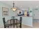 Cozy dining area features a modern chandelier and seamlessly connects to the open-concept kitchen at 8409 Placida Rd # 206, Placida, FL 33946