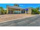 View of the building featuring a covered parking area, welcoming entrance, and well-maintained landscaping at 8409 Placida Rd # 206, Placida, FL 33946