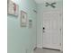 Hallway entrance features coastal decor and a secure door with modern lock, creating a welcoming ambiance at 8409 Placida Rd # 206, Placida, FL 33946