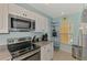 Bright kitchen featuring white cabinets, granite countertops, and stainless steel appliances at 8409 Placida Rd # 206, Placida, FL 33946