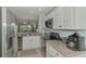Updated kitchen with white cabinets, granite countertops, and stainless steel appliances at 8409 Placida Rd # 206, Placida, FL 33946