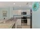 Updated kitchen with white cabinets, granite countertops, and stainless steel appliances at 8409 Placida Rd # 206, Placida, FL 33946