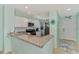 Bright kitchen features granite countertops, stainless steel appliances, and a functional breakfast bar at 8409 Placida Rd # 206, Placida, FL 33946