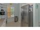 Spacious kitchen area with stainless steel refrigerator and lots of light from the window at 8409 Placida Rd # 206, Placida, FL 33946