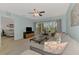 Comfortable living room featuring a plush sectional, TV, and balcony access with serene views at 8409 Placida Rd # 206, Placida, FL 33946