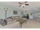 Spacious living room open to the kitchen, featuring a large sectional and modern decor at 8409 Placida Rd # 206, Placida, FL 33946
