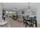 Bright living room boasts a large sectional, ceiling fan, and balcony access with tranquil views at 8409 Placida Rd # 206, Placida, FL 33946
