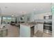 Open-concept condo featuring stainless steel appliances, a breakfast bar, and comfortable living area with balcony access at 8409 Placida Rd # 206, Placida, FL 33946