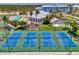 Aerial shot of community pickleball courts and amenities including pool, clubhouse, and green spaces at 8409 Placida Rd # 206, Placida, FL 33946