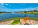 Scenic pond view with a fountain, complemented by comfortable seating and lush landscaping at 8409 Placida Rd # 206, Placida, FL 33946