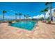 Community pool surrounded by palm trees offers a refreshing escape and tropical ambiance at 8409 Placida Rd # 206, Placida, FL 33946
