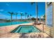Community pool and spa framed by palm trees, adjacent to the pool rules sign at 8409 Placida Rd # 206, Placida, FL 33946