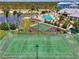 Aerial view of a community with tennis and basketball courts next to a pool and clubhouse at 8409 Placida Rd # 206, Placida, FL 33946