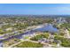 An aerial view shows waterfront neighborhood with homes on canals and lush green landscaping at 8634 Santa Cruz Dr, Port Charlotte, FL 33981