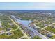 Stunning aerial view of homes lining a tranquil canal in a well-maintained neighborhood at 8634 Santa Cruz Dr, Port Charlotte, FL 33981