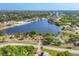 Panoramic aerial shot showcases a beautifully landscaped community park and serene waterfront homes at 8634 Santa Cruz Dr, Port Charlotte, FL 33981