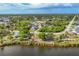 Scenic aerial view of a lakeside community featuring lush green landscaping and beautiful single-Gathering homes at 8634 Santa Cruz Dr, Port Charlotte, FL 33981