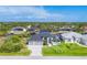 An aerial view showcasing a modern home with a three-car garage and canal access at 8634 Santa Cruz Dr, Port Charlotte, FL 33981