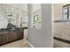 Modern bathroom with dual sinks, a walk-in shower, and elegant tile work at 8634 Santa Cruz Dr, Port Charlotte, FL 33981
