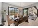Well-lit dining area features a modern chandelier and sliding glass doors to the outdoor space at 8634 Santa Cruz Dr, Port Charlotte, FL 33981