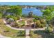 Picturesque aerial view of a landscaped garden, with a pathway and canal in the background at 8634 Santa Cruz Dr, Port Charlotte, FL 33981